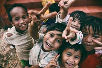 children smiling while looking at the camera